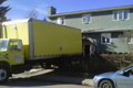 Truck backed up to a house
